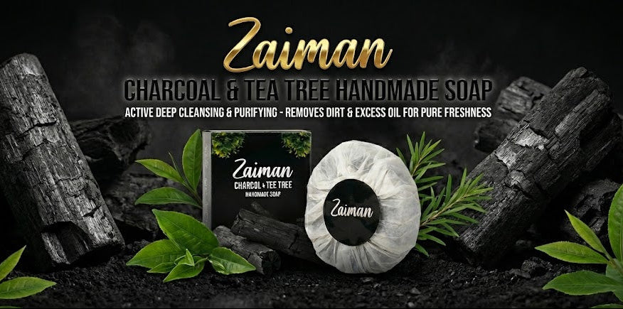Zaiman Charcoal & Tea Tree Handmade Soap with charcoal blocks and leaves on a dark background